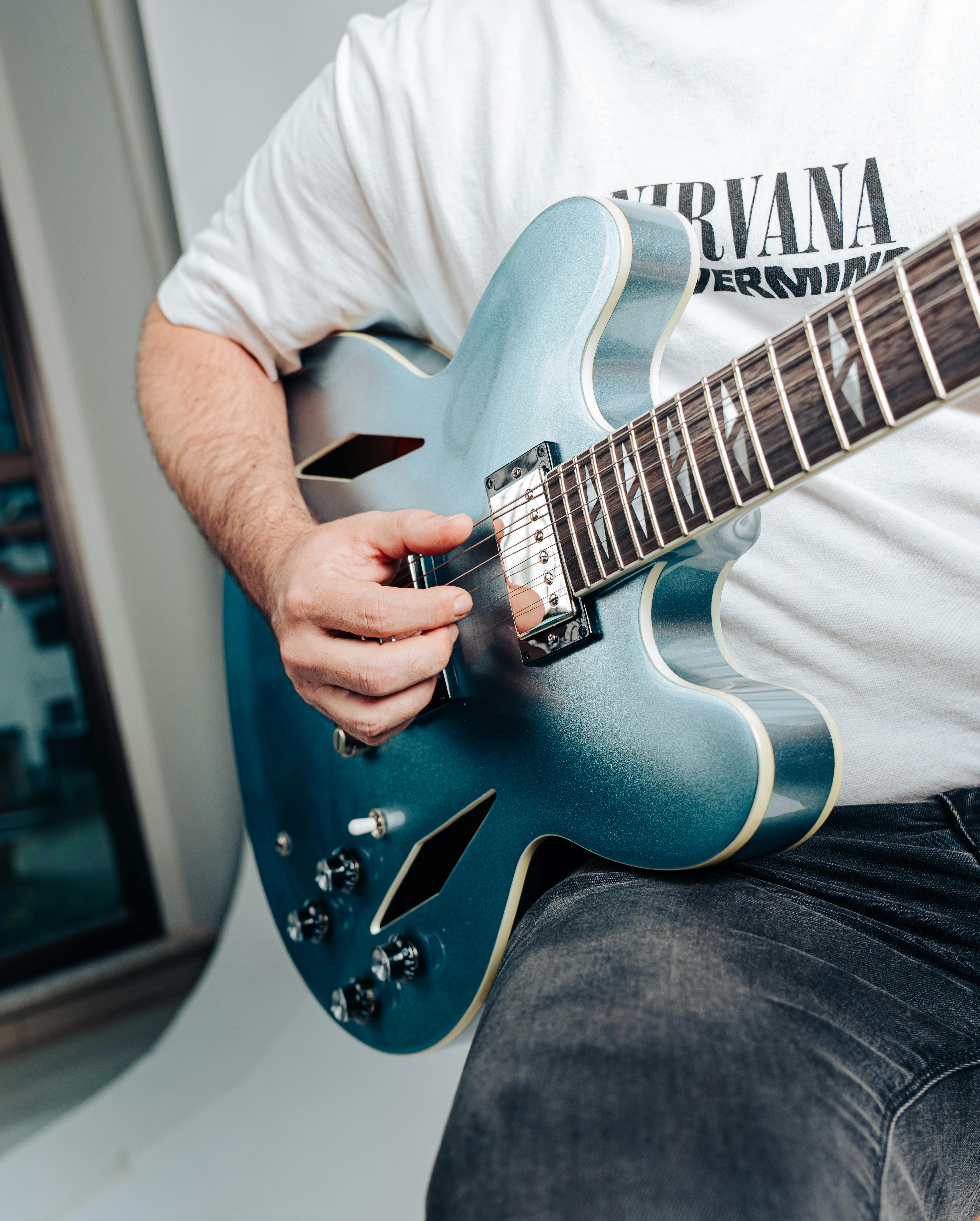 Beginner learning Come As You Are riff on guitar